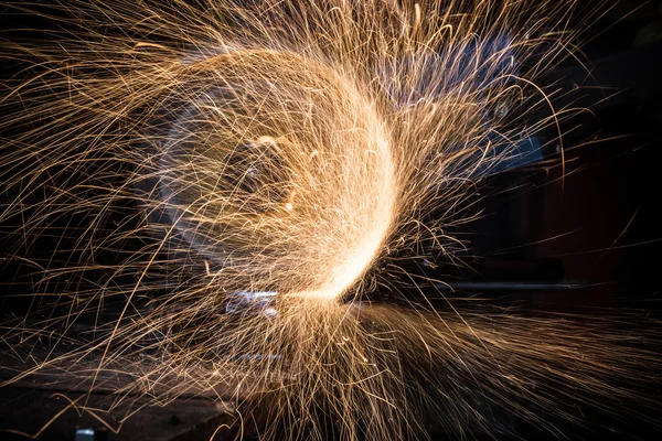 Grinding machine in action with bright sparks.