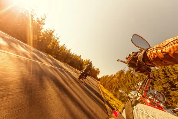 Man seat on the motorcycle on the forest road.