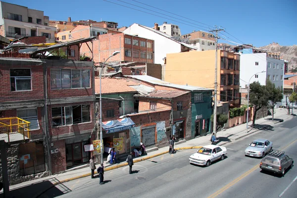 People at the bus station and cars in La Paz city, Bolivia