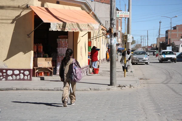 People walk in a street of Uyuni, Bolivia
