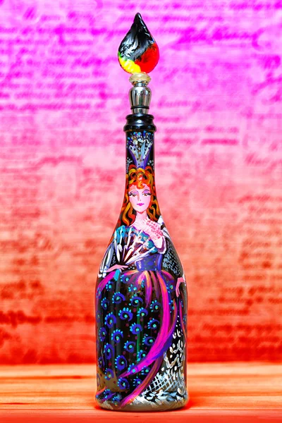 Secular woman in an old beautiful fashionable dress. painted paints on a decorative bottle. Decorative glass bottle with stopper