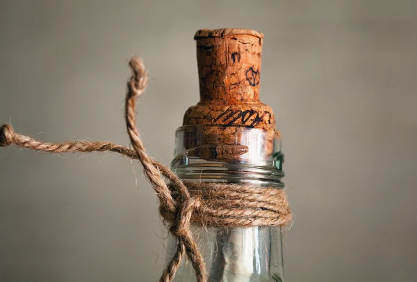 Old bottle with cork and note inside. vintage bottle with a message in the time of pirates