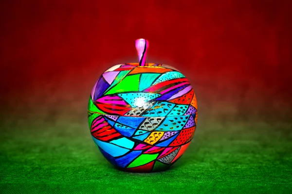 Decorative apple, made of wood and painted by hand paints. modern creative handmade