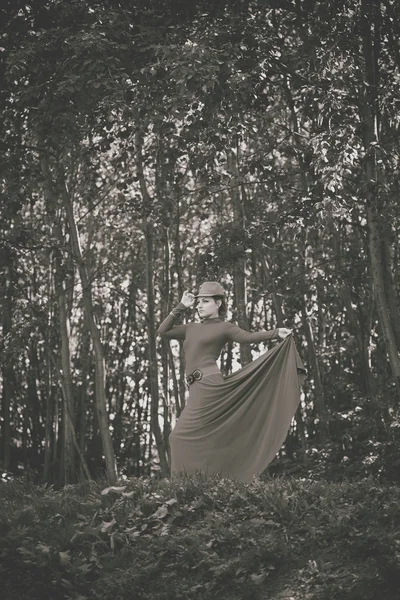 Beautiful retro girl in a dress in the forest. Vintage style