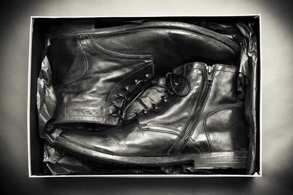Stylized retro shoes in a shoe box, black-and-white photo