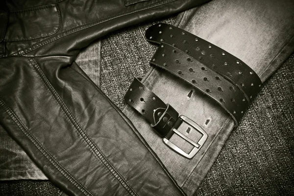 Fashion trend - jeans, leather jacket, leather belt with a buckle