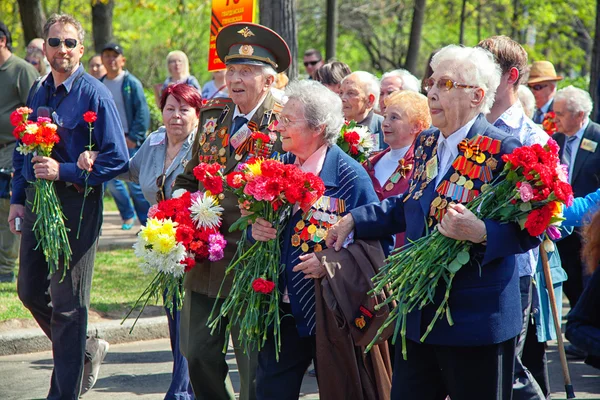 MOSCOW, RUSSIA - MAY 9: World War II veterans are with bouquets of flowers at the Victory Day celebrations. May 9, 2013 in Moscow, Russia.