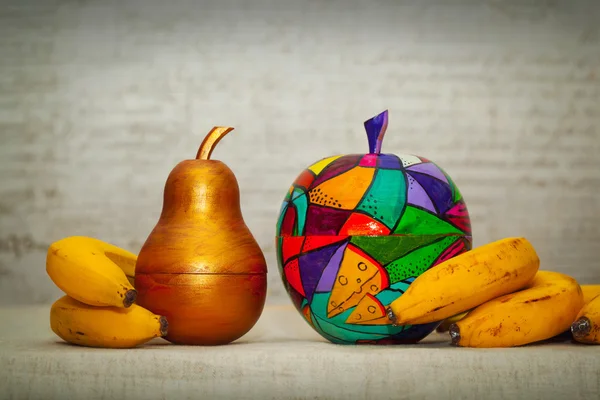Wooden gold colored pear, apple wood with an abstract pattern. Organic bananas. The work of contemporary artist, handmade. Fantastic decorative fruit