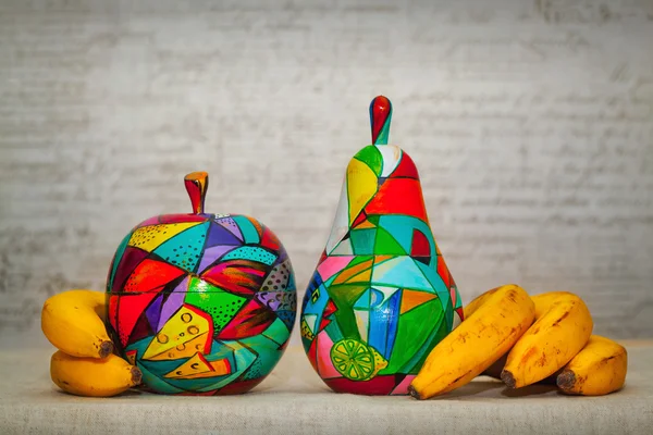 Decorative apple and pear with natural bananas. Fruit colors painted, handmade. The work of contemporary artist