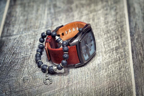 Men's accessories. watch and bracelet on his hand