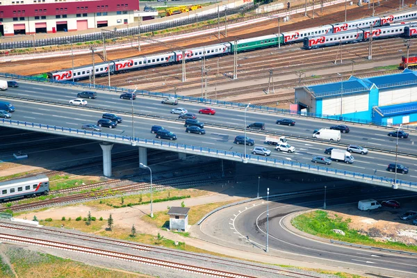 MOSCOW, RUSSIA - JUNE 9, 2014: Cars go fast on the Third Transport Ring. Company Russian Railways Trains go by rail