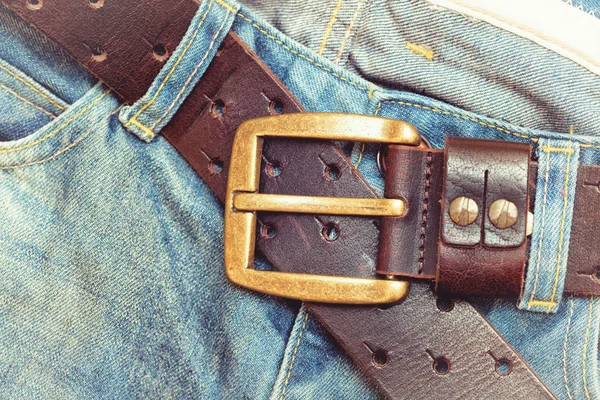 Vintage jeans and a belt with a buckle close-up