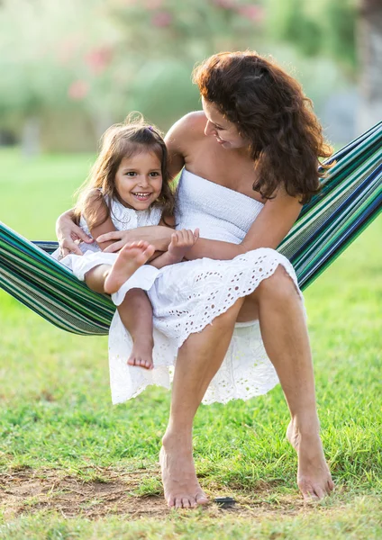 Mother and daughter are resting in the country side.