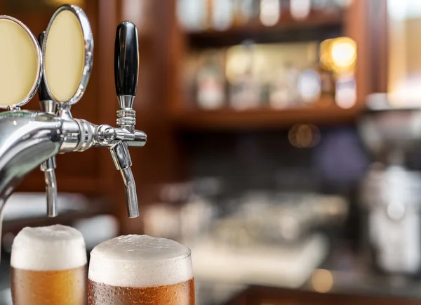 The process of pouring beer into the glass.