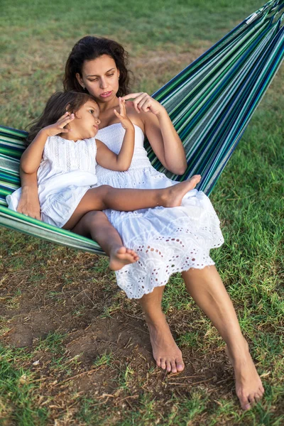 Mother and daughter are resting in the country side.