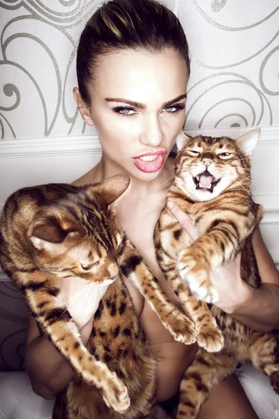 Sensual  woman with two cats