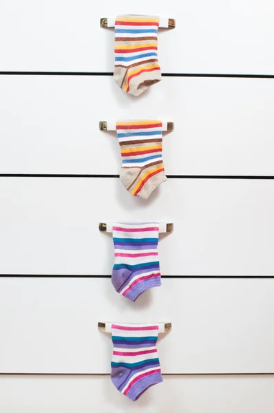Striped socks hanging on the handles