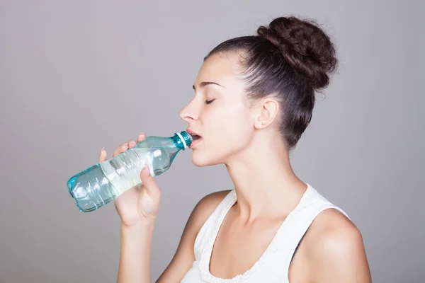Young beautiful woman with bottle of mineral water