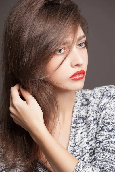 Fashion portrait of beautiful woman in knitted sweater