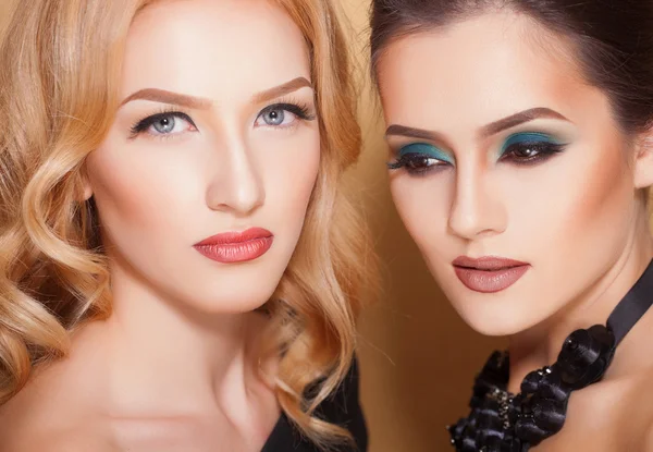 Two sexy and fashionable women with beautiful makeup, closeup shoot