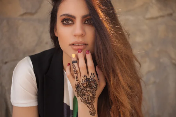 Portrait of a young indian woman in casual style with mehendi on the streets of old city