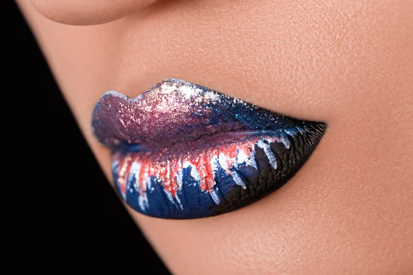 Creative and fashion make up on woman lips. macro photo. studio shot