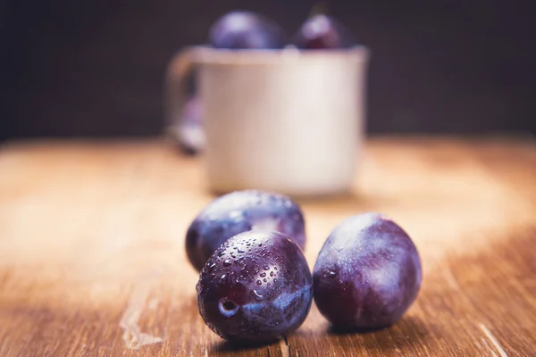 Blue plums in cup