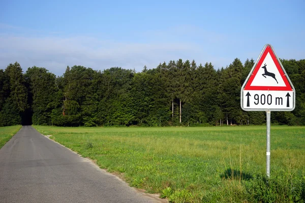 Sign with wild deer on the rural road