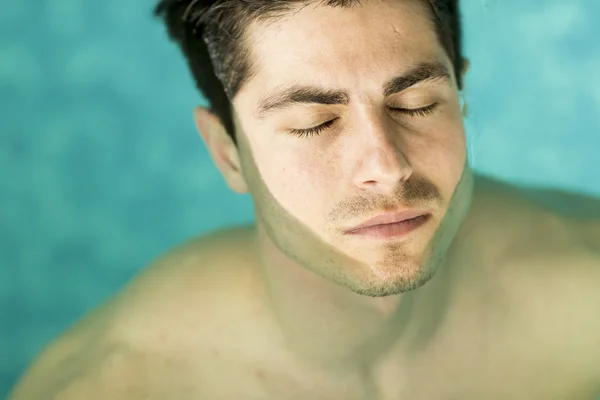 Man floating in the pool