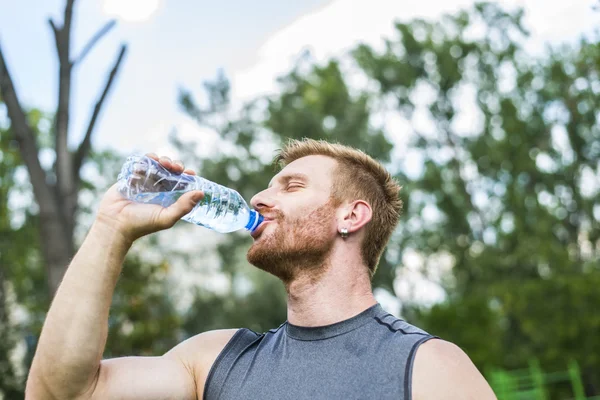 Young athlete drinking water
