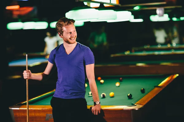 Young man playing pool