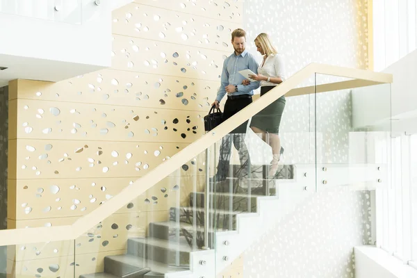 Couple on stairs in the office