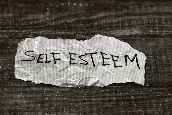 Text self esteem written in a piece of paper