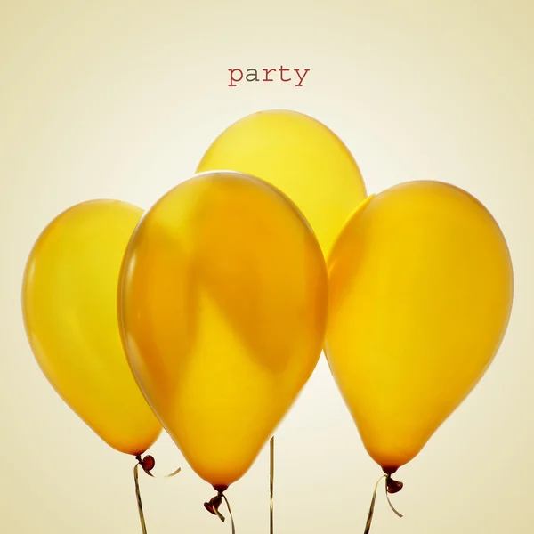 Inflated golden balloons and word party
