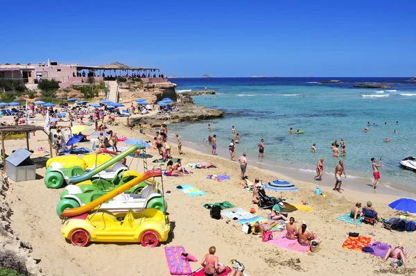 Sunbathers at Cala Conta beach in San Antonio, Ibiza Island, Spa