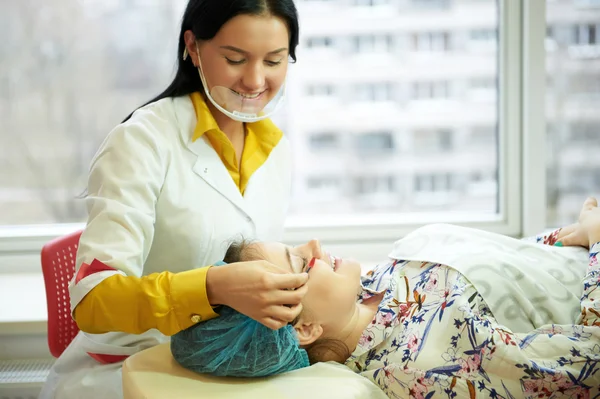 Brows coloring process. Beauty industry.