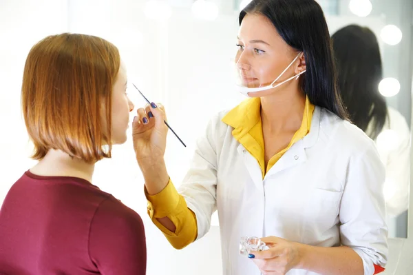 Brows coloring process. Beauty industry.