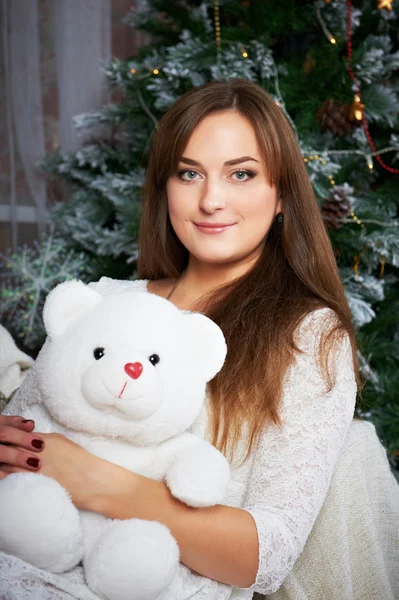 Female holding a cute teddy bear.