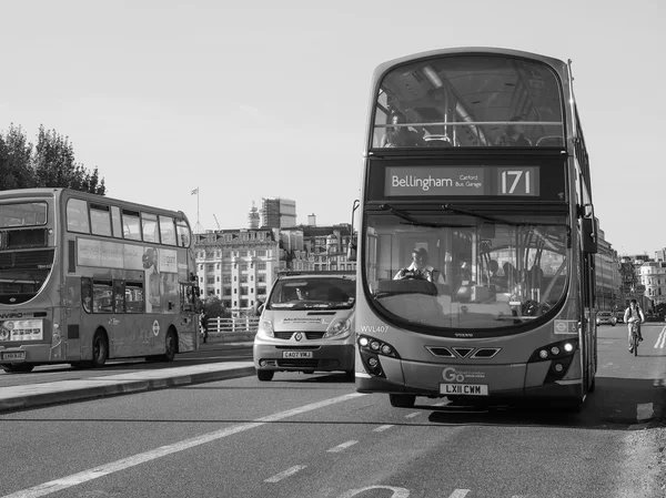 Red bus in London in black and white