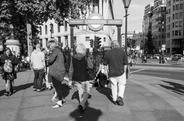 Tourists visiting London in black and white