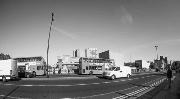 Red bus in London in black and white