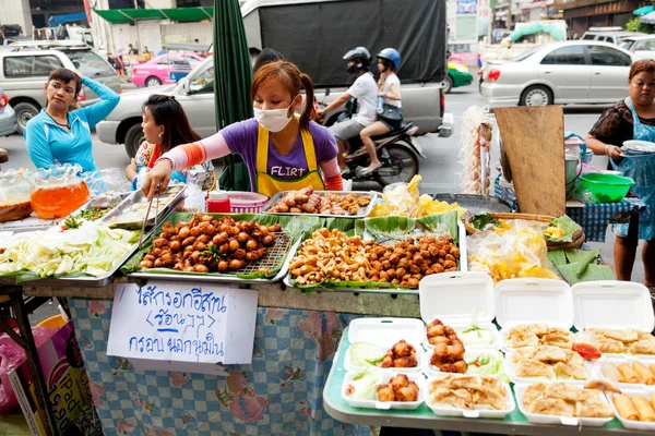 Young Thai woman selling street food