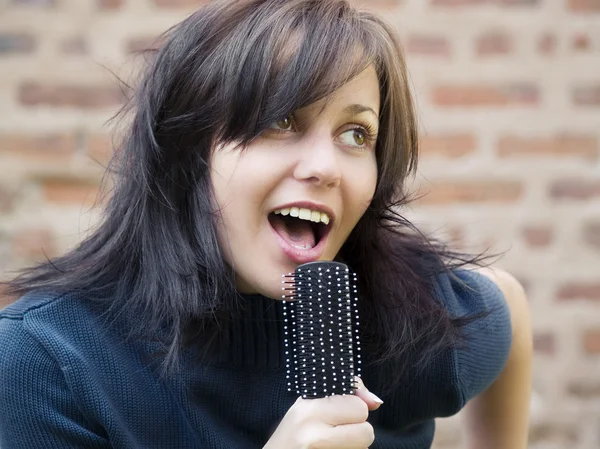 Tousle-headed brunette pretending to sing