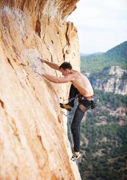 Rock climber on a face of a cliff