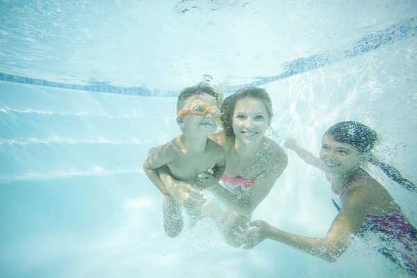 Happy family swimming underwater