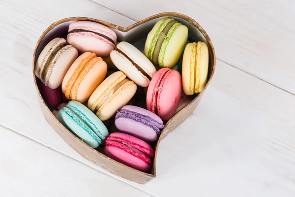 Box with multicolored french macaroon . Trendy sweet colorful co