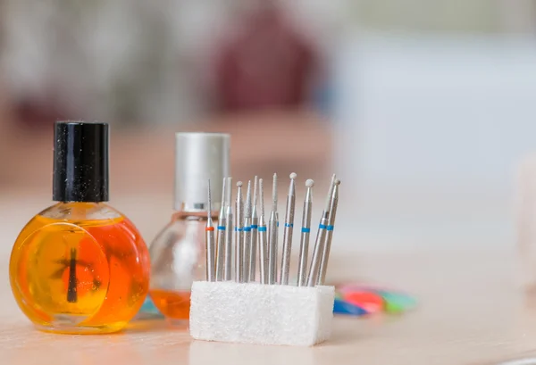 Bottles and tools for manicure after work close-up in nail salon