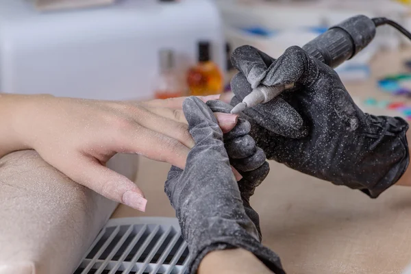 Closeup of manicurist at work, Nails saloon woman nail polish re