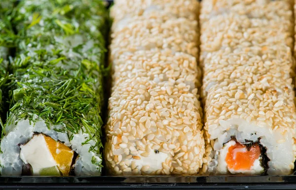 Close-up of sushi roll in the black box, Sushi delivery. shallow
