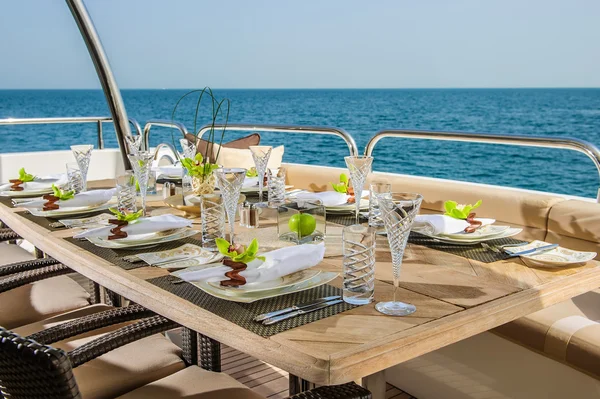 Dinning table on the upper deck in luxurious yacht.